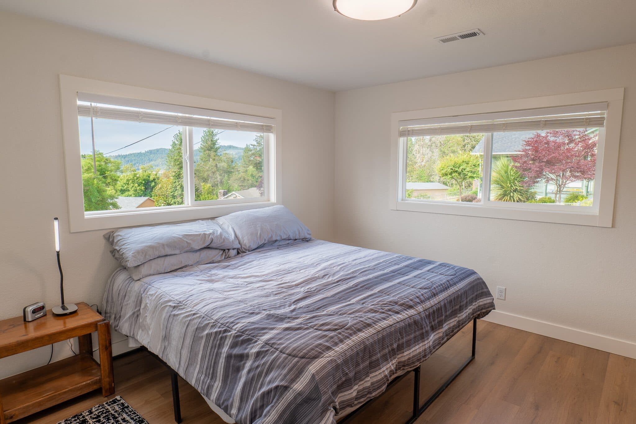 Bedroom with two windows and natural light — real estate photography by Hahn Media, Oregon